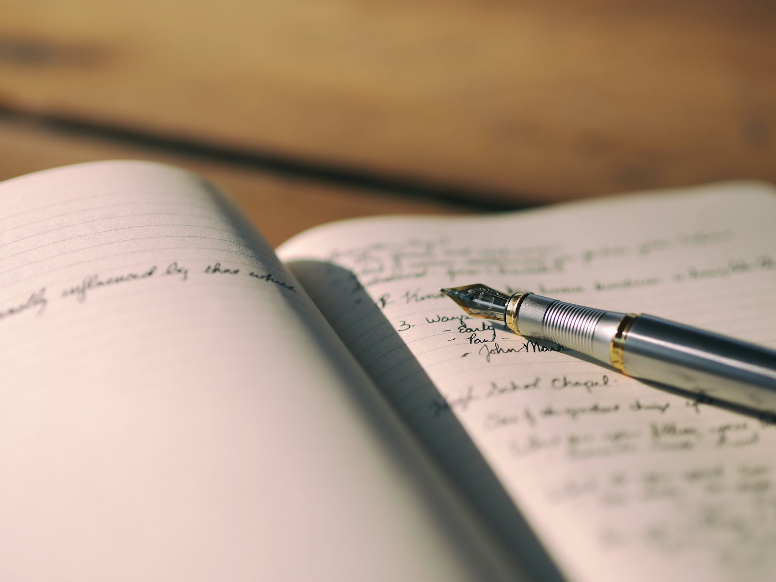 A close-up of a pen resting on white lined paper