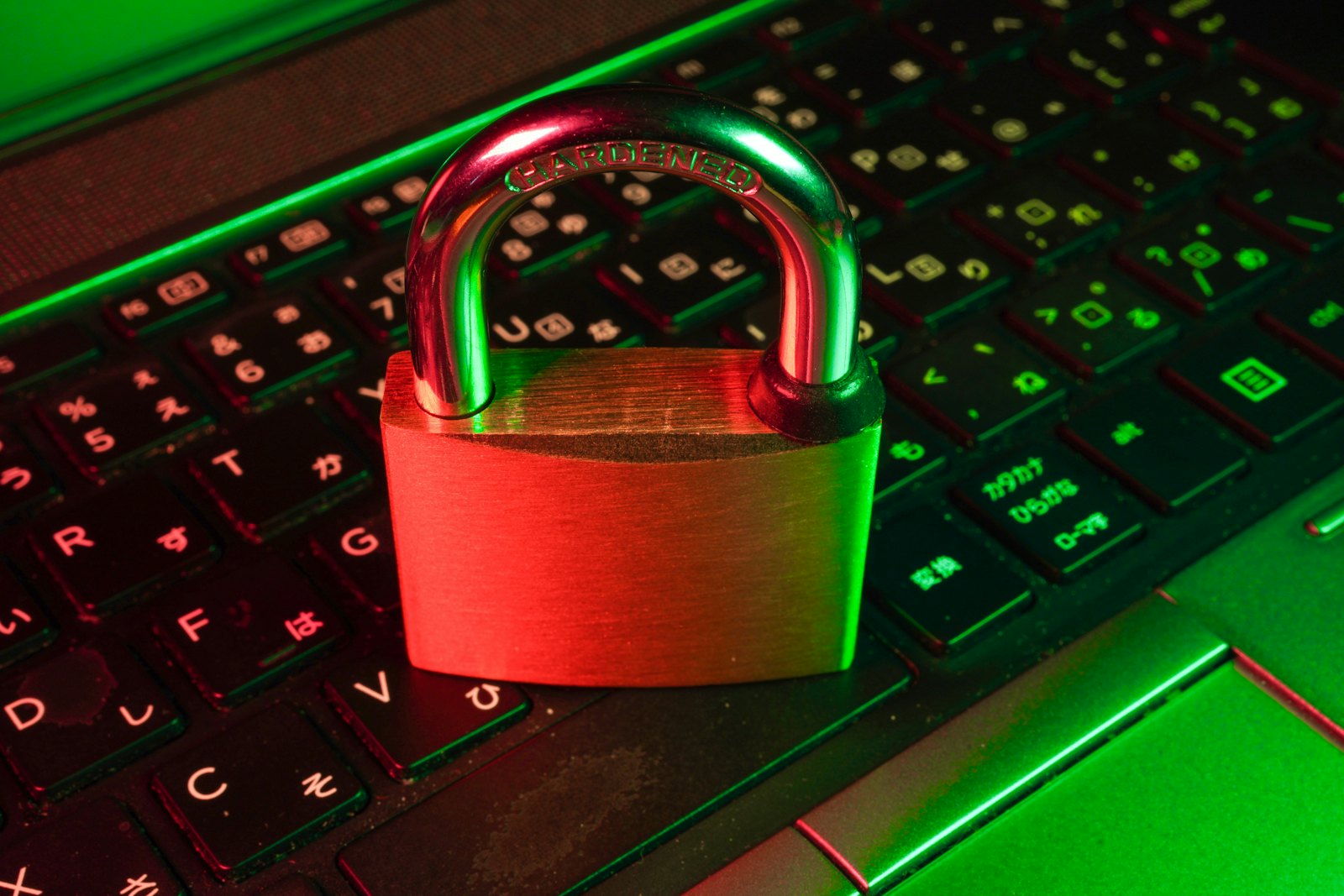 A red padlock resting on a black computer keyboard